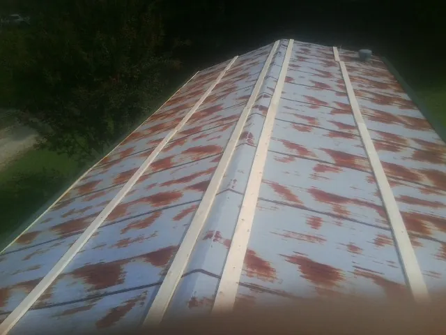 Rusted metal roof panels with new wood purlins before replacement — Storm Damage Roof Repair in State Road by Roofing Brothers